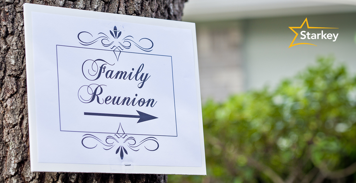 Image of sign posted on a tree that reads "Family Reunion"